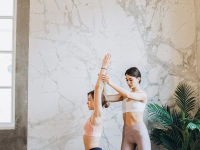 A person holding a strong warrior yoga pose.