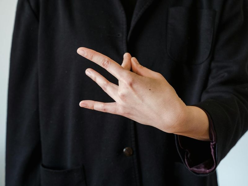 Close-up of a person's hands in a meditative mudra position.